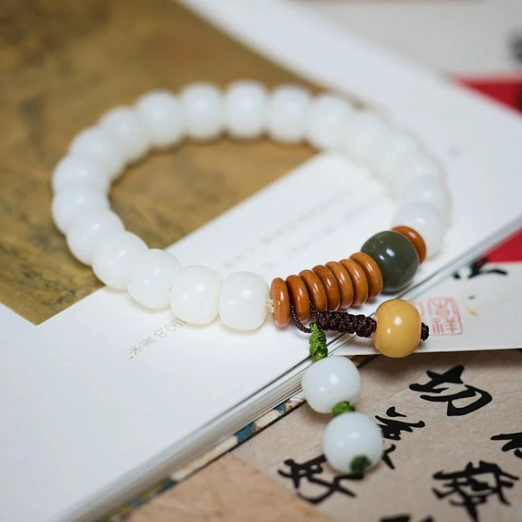 White Seed-Bead Bracelet — White seed-bead bracelet with a single carved gourd charm