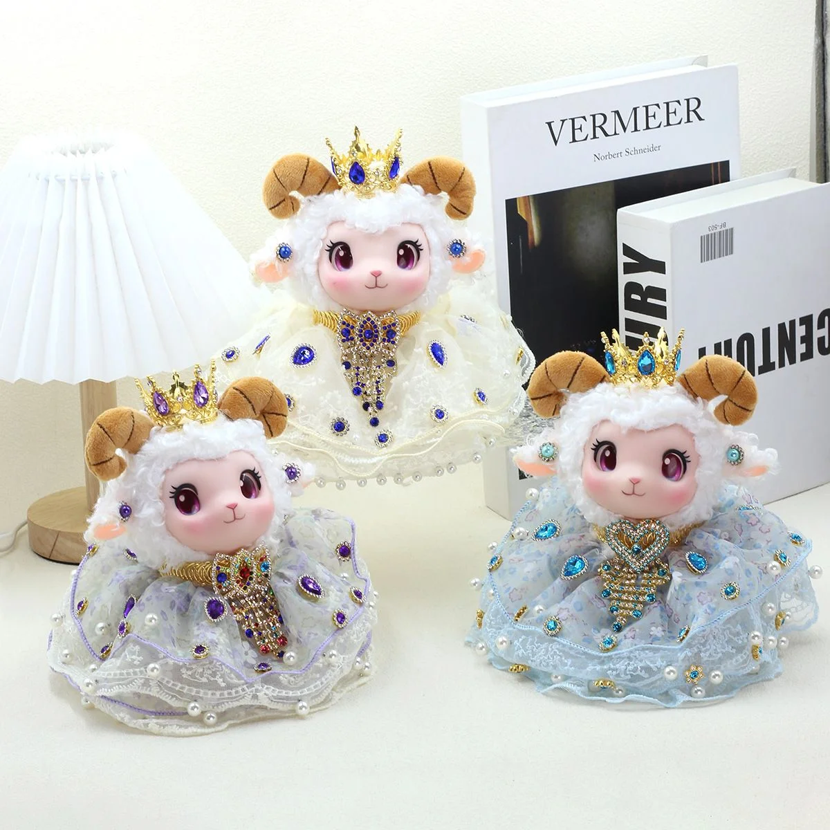 Jewelled Ram Plush — Crowned ram plush figure in a hand-beaded lace gown, shown in blue, pink and ivory