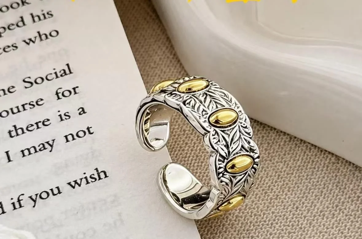 Two-Tone Open Ring — Wide silver-tone open ring with gold-tone oval accents on a textured band